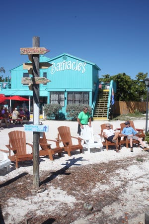 Visitors enjoy the sun near Barnacle's restaurant on North Captiva, Florida. [Steve Stephens]