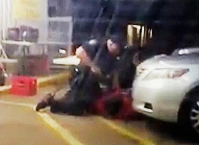FILE - In this July 5, 2016 image made from video provided by Arthur Reed, Alton Sterling is restrained by two Baton Rouge police officers, one holding a gun, outside a convenience store in Baton Rouge, La. Moments later, one of the officers shot and killed Sterling, a black man who had been selling CDs outside the store, while he was on the ground.  The investigation of the deadly police shooting that inflamed racial tensions in Louisiana’s capital city has ended without criminal charges against two white officers who confronted Sterling. . Experts in police tactics think the bloodshed could have been avoided if the Baton Rouge officers had done more to defuse the encounter with Sterling. .(Arthur Reed via AP, File
