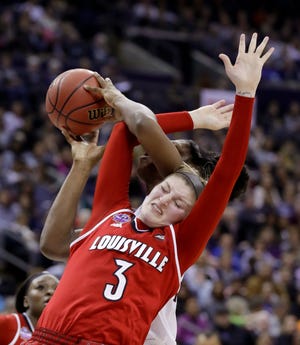 Mississippi State's Teaira McCowan gets tangled up with Louisville's Sam Fuehring (3) while shooting during the first half of semifinal in women's NCAA Final Four won by Mississippi State 73-63 in overtime on Friday night in Columbus, Ohio. [AP Photo/Ron Schwane]