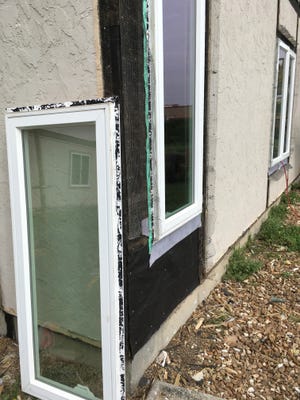 Flashing tape should be installed under a window flange, not over its top as with the old window shown at left. Proper shiplapping of the secondary barrier — building felt paper — will prevent the intrusion of moisture and subsequent repairs. 

[Submitted by Ron Barnhart]