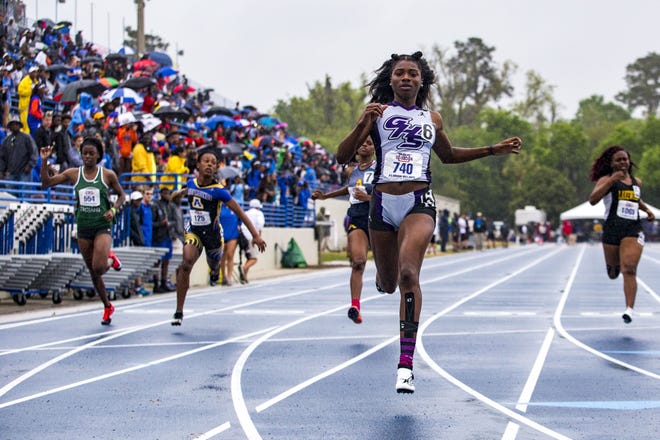 Gainesville High's Tamari Davis crosses the finish line Friday as she wins the girls 100-meter dash in 11.34 at the Florida Relays at Percy Beard Track. [Lauren Bacho/Staff photographer]