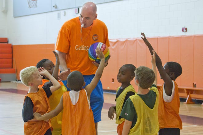 Pat Burke, shown here coaching kids at a camp, knew how to get the last word in on hecklers during his NBA playing days. [DAILY COMMERCIAL FILE]