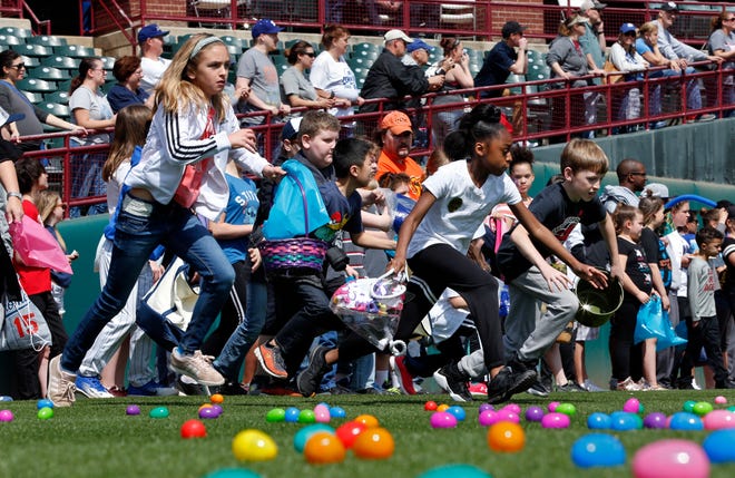 Children rush to gather eggs Saturday during the Easter egg hunt portion of the Oklahoma City Dodgers' Fan Fest at Chickasaw Bricktown Ballpark. [PHOTO BY STEVE SISNEY, THE OKLAHOMAN]