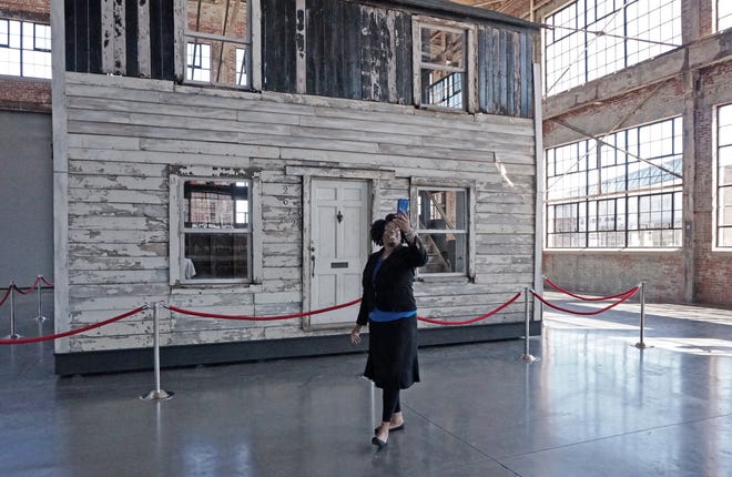 Nancy Perry, pastor at Shiloh Gospel Temple in Providence, takes a selfie with the reconstructed house that belonged to Rosa Parks' brother. The house is on exhibit this weekend at the WaterFire Arts Center in Providence. [The Providence Journal / Sandor Bodo]