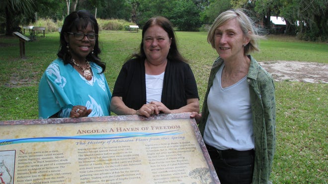 Daphne Towns of Oaktree Community Outreach, left, and Reflections of Manatee members Trudy Williams and Sherry Svekis stand at a marker in Manatee Mineral Spring Park that designates the site as the likely location of Angola, a 19th century settlement of runaway slaves. Reflections of Manatee is preparing an application for the National Park Service to consider the park in its listings of Underground Railroad historic sites. 

[HERALD-TRIBUNE STAFF PHOTO / DALE WHITE]