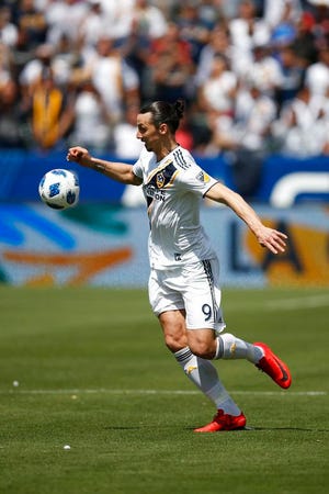 Los Angeles Galaxy's Zlatan Ibrahimovic, of Sweden, dribbles the ball during the second half of an MLS soccer match against the Los Angeles FC Saturday, March 31, 2018, in Carson, Calif. (AP Photo/Jae C. Hong)