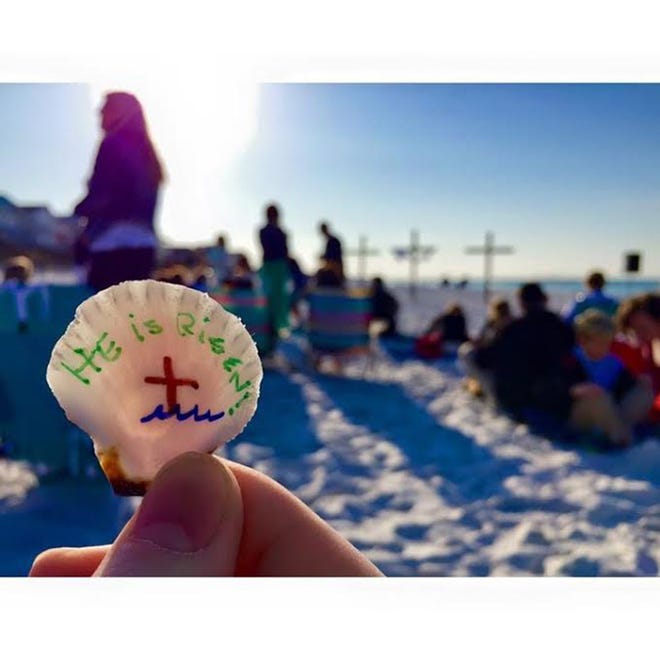 A guest holds up a seashell at a previous Hope on the Beach Easter service. The shells will be distributed again this year, between the church's 6:30 and 8 a.m. services. [CONTRIBUTED PHOTO]