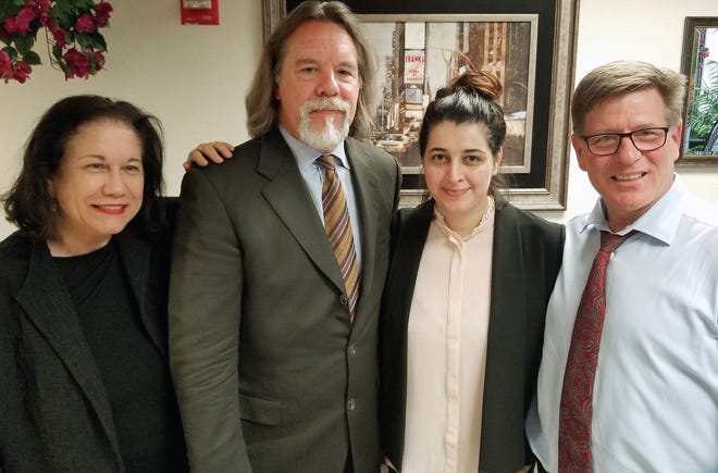 Noor Salman, second from right, and her attorneys pose for a photo after Salman was acquitted of lying to the FBI and helping her husband attack the Pulse nightclub in Orlando. The attorneys, Linda Moreno, Fritz Scheller, Charles Swift pose with Salman from left. (Susan Clary via AP)