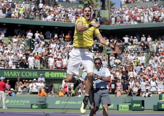 Former Georgia tennis player John Isner celebrates after defeating Alexander Zverev, of Russia, during the final at the Miami Open tennis tournament Sunday. (AP Photo/Lynne Sladky)