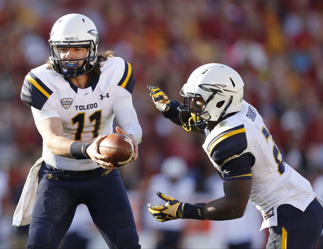 Toledo quarterback Logan Woodside (11) gets ready to hand the ball off to running back Terry Swanson during a game against Iowa State. Swanson, an Aliquippa graduate, hopes to hear his name called during the NFL Draft later this month. [AP Photo/Justin Hayworth]