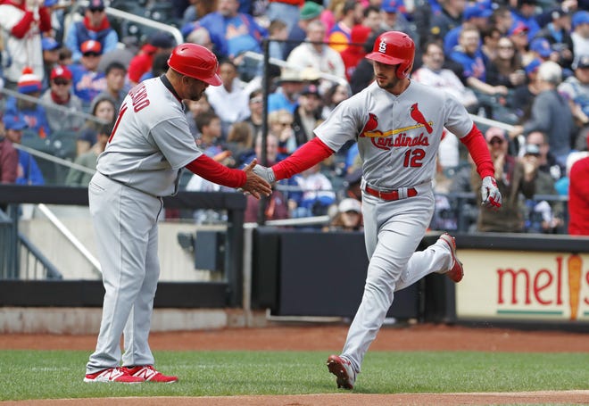 St. Louis Cardinals third base coach Jose Oquendo, left, congratulates the Cardinals' Paul DeJong who hit a solo home run during the second inning of a MLB game against the New York Mets on Sunday. [AP Photo/Kathy Willens]