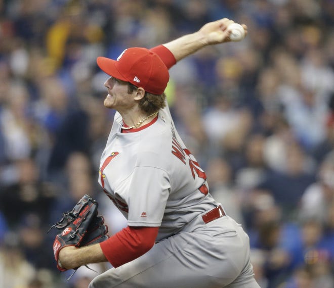 St. Louis Cardinals starting pitcher Miles Mikolas throws a pitch to the Milwaukee Brewers in the first inning at Miller Park in a home opener baseball game Monday in Milwaukee. Mikolas won in his first big league game after a three-year stint in Japan and hit a home run in the Cardinals' 8-4 win. [Jeffrey Phelps/The Associated Press]