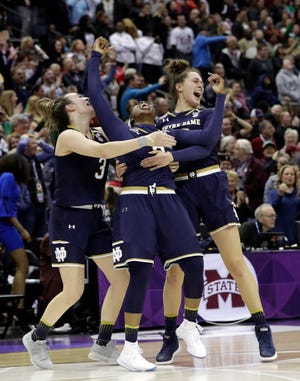 Notre Dame's Arike Ogunbowale, center, celebrates with teammates Marina Mabrey, left, and Kathryn Westbeld after defeating Mississippi State, 61-58, in Sunday's NCAA women's national final in Columbus, Ohio. [Tony Dejak/AP]