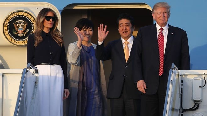 WEST PALM BEACH, FL - FEBRUARY 10: President Donald Trump and his wife Melania Trump arrive with Japanese Prime Minister Shinzo Abe and his wife Akie Abe on Air Force One at the Palm Beach International airport as they prepare to spend part of the weekend together at Mar-a-Lago resort on February 10, 2017 in West Palm Beach, Florida. The two are scheduled to get in a game of golf as well as discuss trade issues. (Photo by Joe Raedle/Getty Images)
