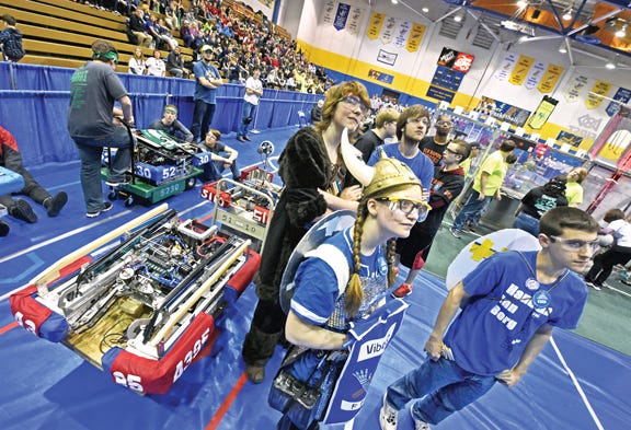 Arianna Bressler, donned in Viking best, and her "Team Viborgs" from Dundee, listen to opening ceremonies during the 2016 FIRST Robotics District Competition in Sault Ste. Marie. At least 40 high school teams from all corners of Michigan will converge on Lake Superior State University April 6-7 for this year’s event. Teams have had six weeks to brainstorm, design, and build a fully functional wheeled robot the size of a large dog that must cross eight different obstacles, then carry and launch 10-inch diameter foam balls into towers on opposite sides of a 27-by-54-foot field. Top finishers move on to state finals April 11-16 in Saginaw.