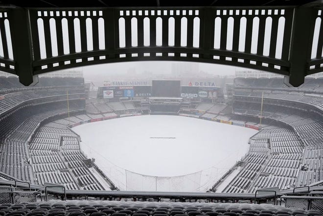 Snow covers the field before a scheduled New York Yankees' home opener game against the Tampa Bay Rays at Yankee Stadium Monday, April 2, 2018 in New York. The game was postponed due to weather and rescheduled for Tuesday. (AP Photo/Seth Wenig)