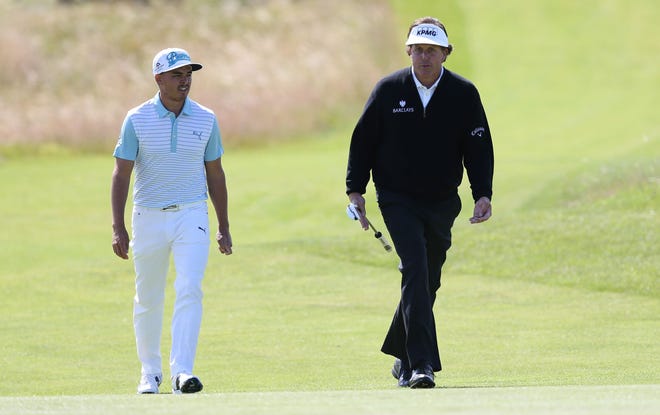 Rickie Fowler, left, and Phil Mickelson will play in the same group in Round 1 of the Masters Thursday. [AP File Photo]