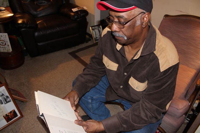 Fred Seay, president of the Burlington chapter of the NAACP, looks at his signed copy of Martin Luther King Jr.'s book, "Strength of Love," Tuesday in his home in Keokuk. Today is the 50th anniversary of King's assassination. [Michaele Niehaus/thehawkeye.com]