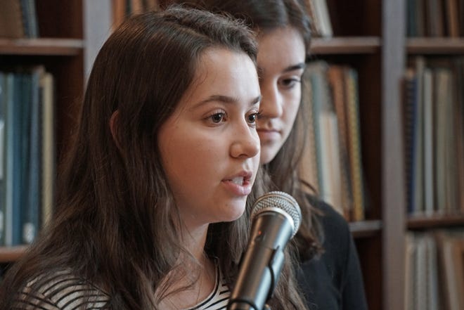 Camille Brousseau and, behind her, Sabrina Goncalves, teenagers from Temple Habonim, speak at the R.I. State House on Tuesday as leaders from a variety of faith communities urge passage of legislation to protect abortion rights in Rhode Island. [The Providence Journal / Sandor Bodo]