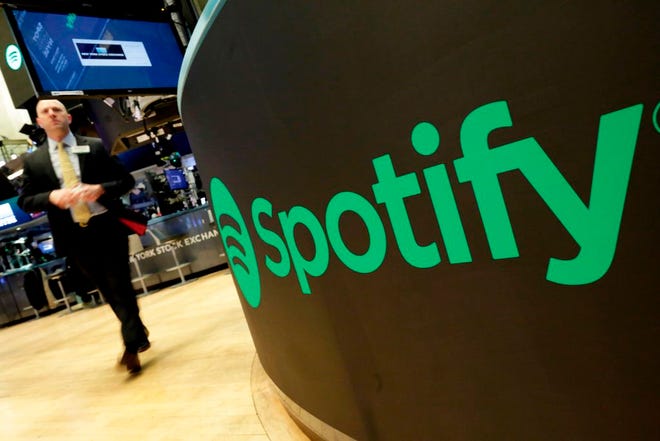 A trading post sports the Spotify logo on the floor of the New York Stock Exchange, Tuesday, April 3, 2018. (AP Photo/Richard Drew)