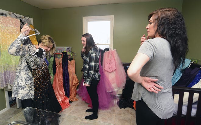 Ashley Genova, right, runs the nonprofit group Before Midnight, which helps teens who otherwise would not be able to afford items such as gowns, jewelry and makeup for their proms. Genova talks with Katie Felsing 17, a junior at Laurel High School, and her mom, Betty Jo Felsing.[Lucy Schaly/BCT staff]