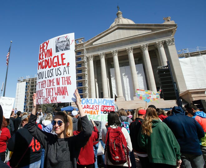 Carl Albert senior Andie McDermott, 18, holds a sign Wednesday referring to comments by state Rep. Kevin McDugle, during the third day of a walkout by Oklahoma teachers at the state Capitol. [Photo by Nate Billings, The Oklahoman]
