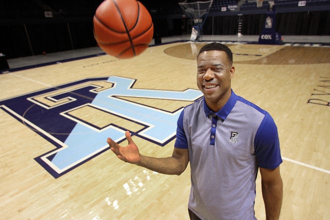 David Cox tosses a basketball Wednesday on the court of the Ryan Center at the University of Rhode Island. He replaces Dan Hurley as the head coach of the Rams. [The Providence Journal / Glenn Osmundson]