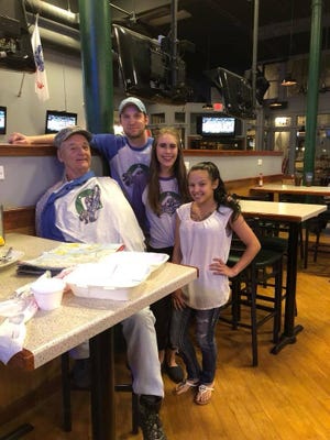 Actor and comedian Bill Murray poses for a picture with staff of Third Base Restaurant and Bar. He stopped in Fayetteville on his way to Philadelphia to check out construction of the downtown baseball stadium. [Contributed photo]