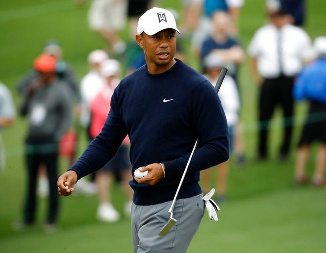 Tiger Woods looks over a putt on the second hole during a practice round for the Masters golf tournament Wednesday, April 4, 2018, in Augusta, Ga. (AP Photo/Chris Carlson)