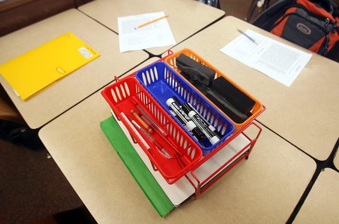 Students in a fourth grade classroom share supplies at Verner Elementary School. (Staff file photo)