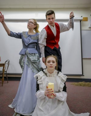 Allison Bouchard, left, Stiles Zuschlag, and Sarah Smith pose during a scene of "Isles in the Moon" during a recent reheasal at Noble High School in North Berwick, Maine. The show will be performed Sunday, Monday and Tuesday, April 8-10, at the school. [Shawn St. Hilaire/Fosters.com]