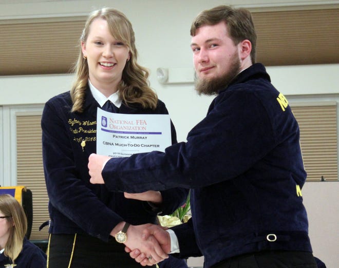 FFA State President and CBNA Alum Sydney Wilson presenting Patrick Murray with his proficiency in Outdoor Recreation. [Courtesy photo]