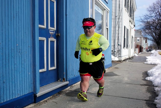 John Young makes his way along his marathon training route in Salem in March. [The Associated Press]