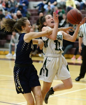 Hopewell's Taylor Parrish fouls Riverside's Sydney Wolf (11) during the Quigley Classic all-star basketball game Friday night at Quigley Catholic High School. [Sally Maxson/BCT staff]