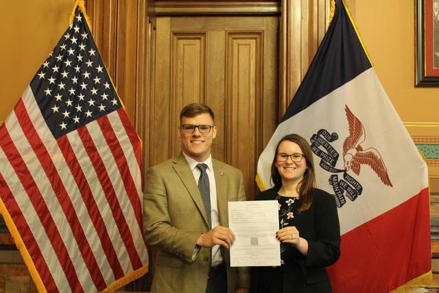 Thompson signing and turing in his candidacy papers. Photo courtesy of the Iowa Secretary of State’s Office