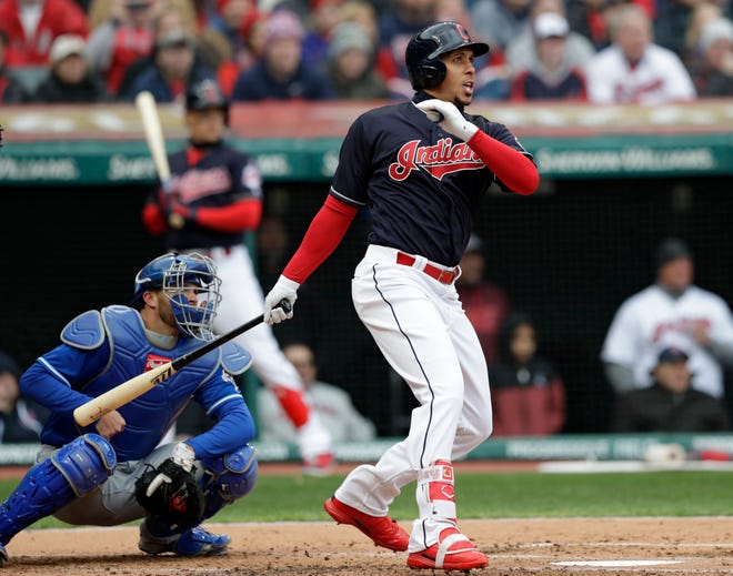Cleveland Indians' Michael Brantley, right, watches his two-run single off Kansas City Royals starting pitcher Danny Duffy in the first inning of a home-opener baseball game, Friday, April 6, 2018, in Cleveland. Jason Kipnis and Jose Ramirez scored on the play. (AP Photo/Tony Dejak)