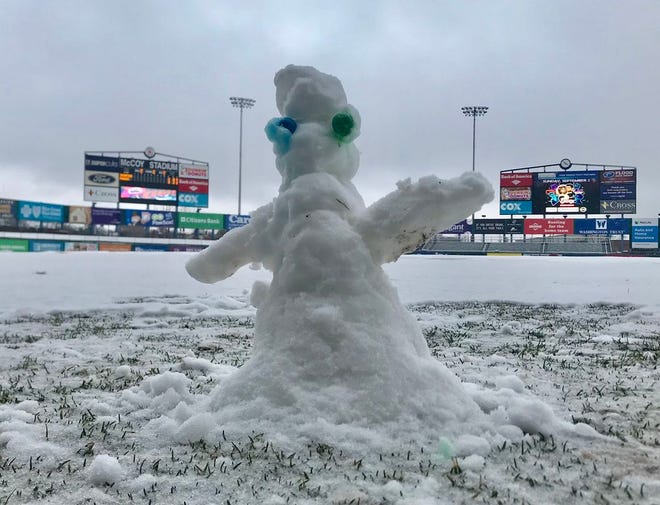 A snowman a little more than a foot tall waits to see if the PawSox home opener is on for tonight or not. [The Providence Journal/Glenn Osmundson]
