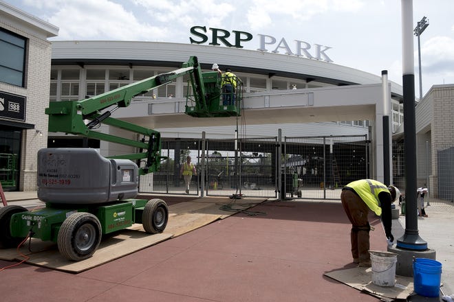 Construction crews work to put the finishing touches on the SRP Park entranceway Friday. [MIKE ADAMS/SPECIAL]