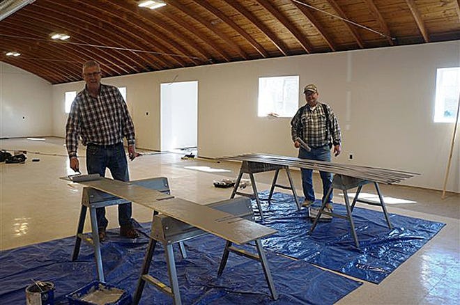 Legion members George Wirt, left, and David Lambin paint trim to be installed at the¬†Alpha American Legion building following the plaster project. [SHERRIE TAYLOR/The Register-Mail]