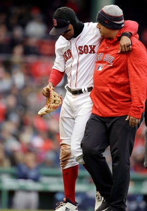 Red Sox shortstop Xander Bogaerts had to be helped to the dugout after injuring his ankle when chasing an errant throw by left fielder J.D. Martinez in the seventh inning of Sunday's game against the Rays.