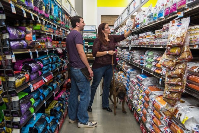 An employee assists a customer with dog food at a Petco store in Clark, New Jersey on Oct. 2, 2015. MUST CREDIT: Bloomberg photo by Ron Antonelli.
