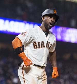San Francisco Giants right fielder Andrew McCutchen reacts after hitting a three-run home run for a walkoff win against the Los Angeles Dodgers in the 14th inning of a game played Saturday night in the City by the Bay. [JOHN HEFTI/THE ASSOCIATED PRESS]
