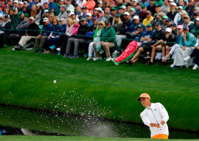 Rickie Fowler hits from a bunker on the 16th hole during the fourth round at the Masters golf tournament Sunday, April 8, 2018, in Augusta, Ga. (AP Photo/Matt Slocum)