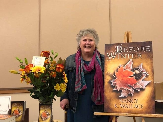 Ellwood City author Nancy Wallace with a mockup of the front cover of "Before Winter," the finale in her Wolves of Llise trilogy. [Submitted photo]