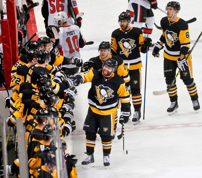 The Penguins' Phil Kessel, front center, is greeted by teammates after he scored against the Ottawa Senators during the third period of an NHL hockey game, in Pittsburgh. In the East, Boston suddenly looks like the team to beat, Pittsburgh has won the Stanley Cup two years in a row and awakened from a midseason funk and Tampa Bay has shown flashes of being unstoppable. [AP Photo/Keith Srakocic, File]