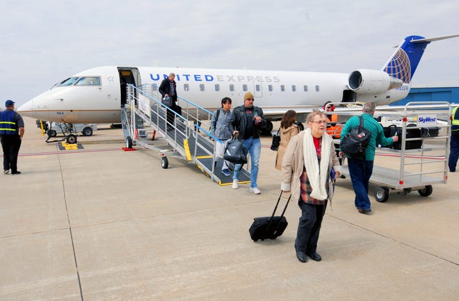 Passengers arrive at Salina Regional Airport on a United Express flight, operated by SkyWest Airlines, from Chicago. The airport is likely to be the site of an overnight maintenance base for SkyWest after approval of financial incentives from the City of Salina and Saline County.