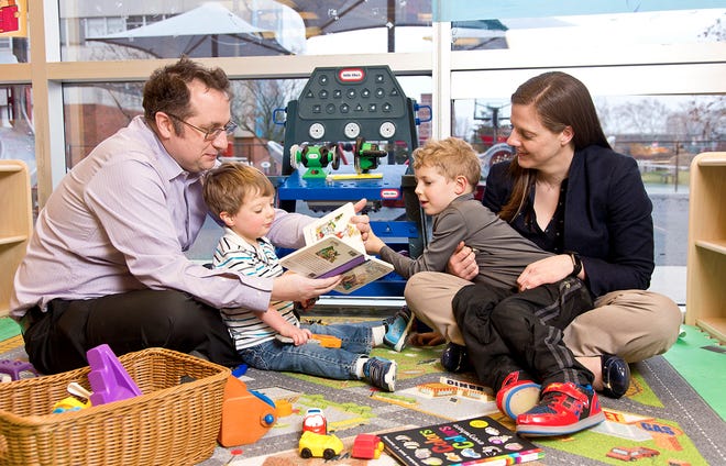 Parents Ryan and Christina O'Keeffe read with their sons, Conor (left) and Devin, at the Nisonger Early Learning Program.