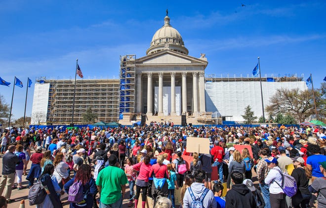 Teachers gather on the south side of the Capitol as they finish their 110 mile walk from Tulsa during the ninth day of a walkout by Oklahoma teachers at the state Capitol in Oklahoma City, Okla. on Tuesday, April 10, 2018.  Photo by Chris Landsberger, The Oklahoman