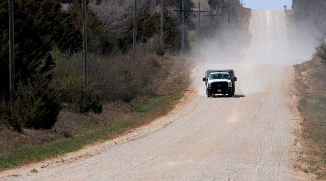 A truck travels east Tuesday afternoon on West Water Well Road. The road is high on the list of Saline County's priorities for repair. [TOM DORSEY / SALINA JOURNAL]