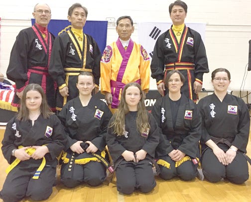 Pictured, from left to right, are (back row) 6th degree master Karl Stolt, 9th degree master Sung Jin Suh, Grandmaster Suh In Hyuk, 8th degree master Alex Suh; (front row) Elizabeth Cole, JKN Faith Cole, Anna Cole, JKN Michele Cole, and Dena Bliss.
